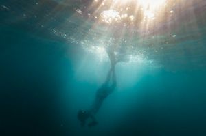 Deep in the sea: underwater photo of person diving