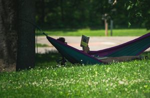 Woman reading a book in a hammock